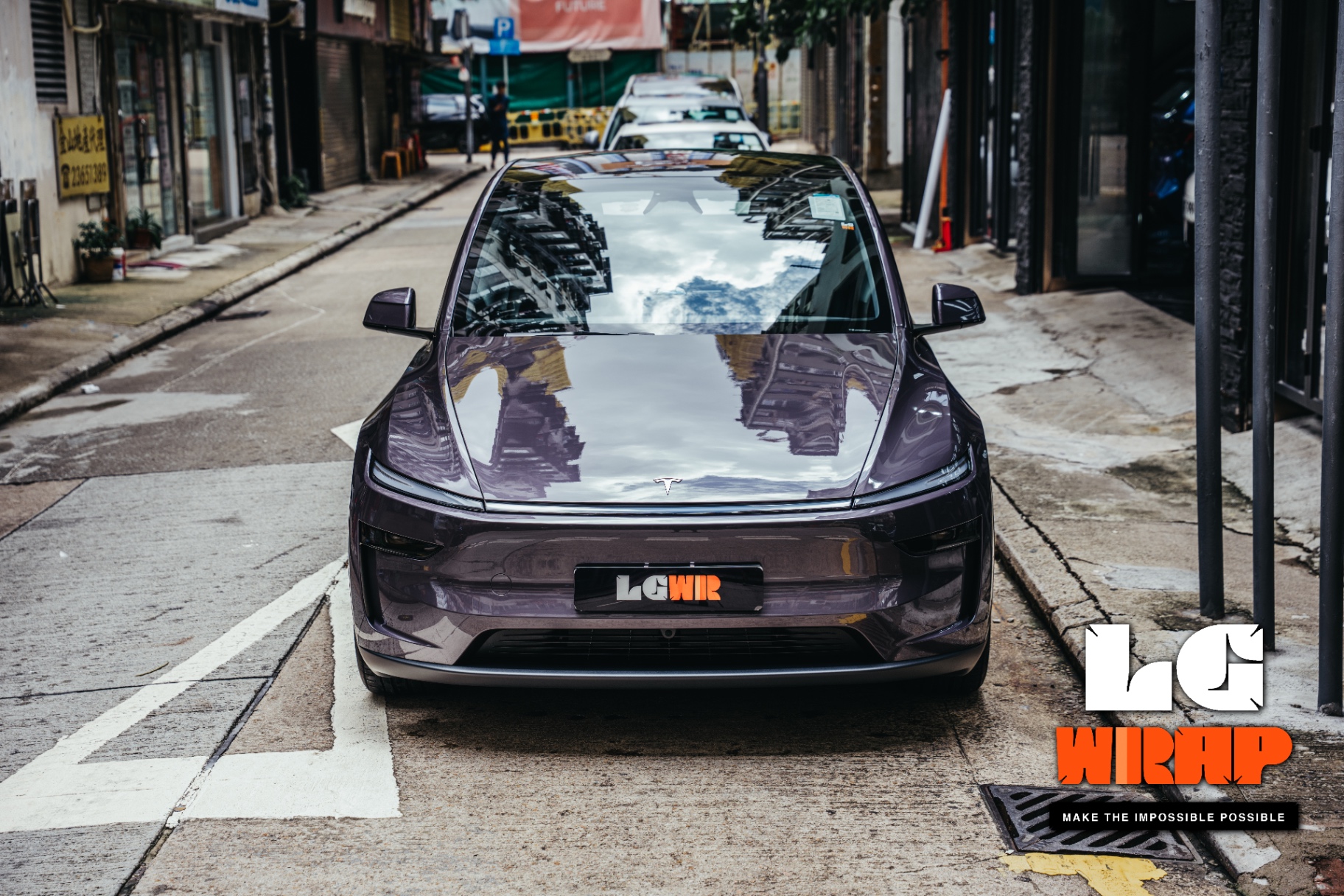 Front street view of a dark purple electric car after Colour PPF, showcasing the complete visual effect after legal colour change