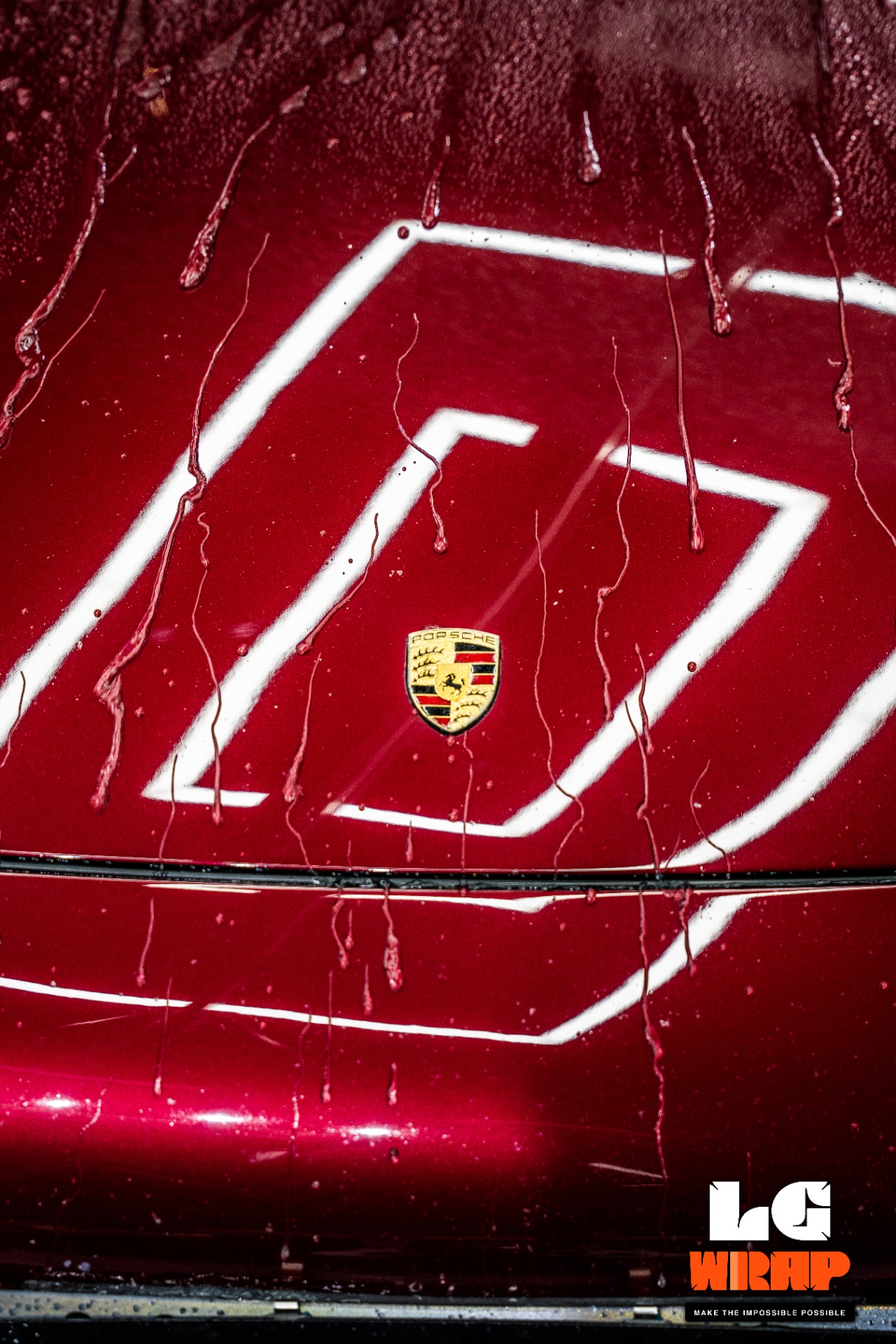 Porsche 993 hood after coating showing extreme hydrophobic water beading effect and Porsche crest close-up