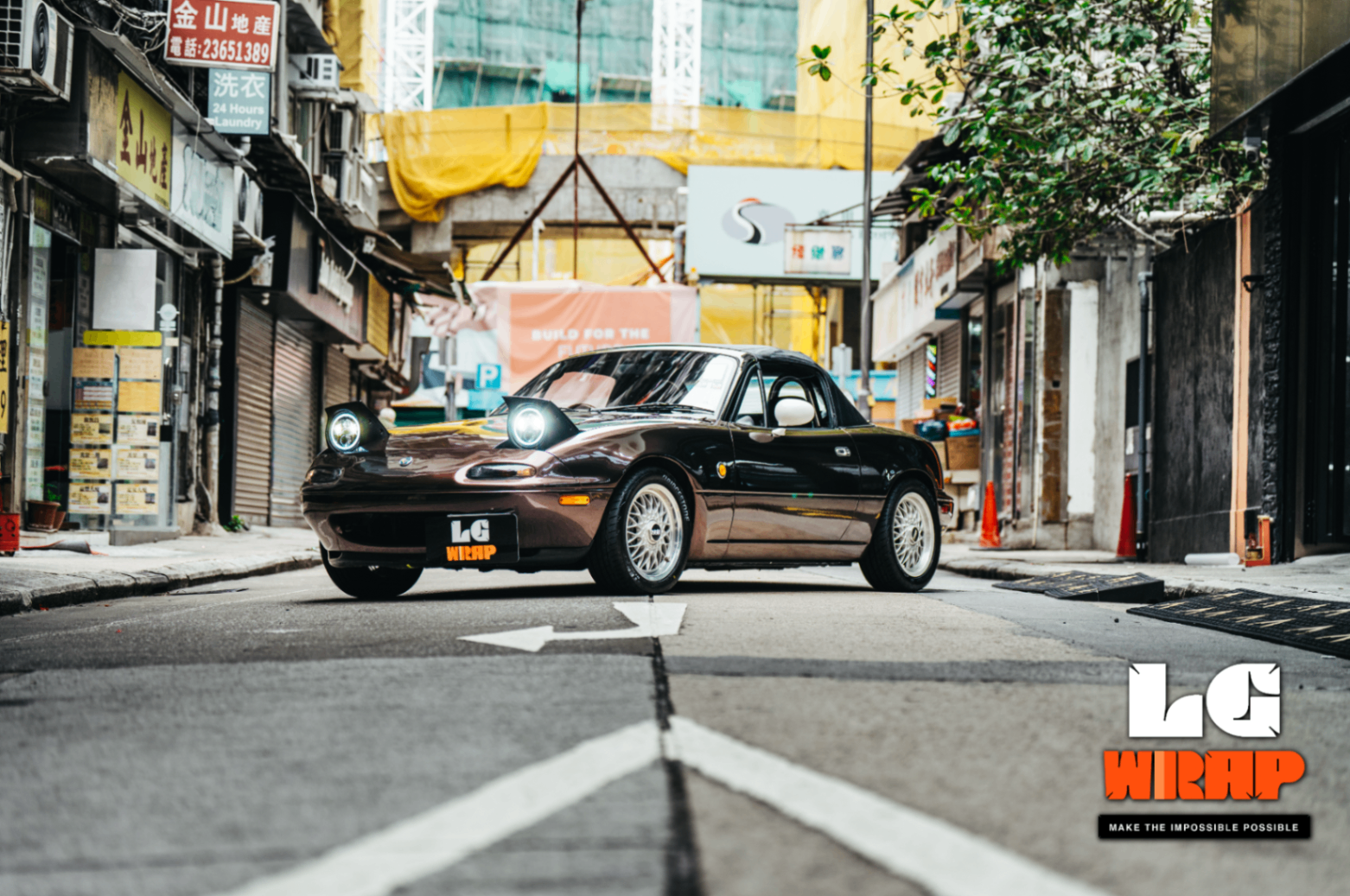 45-degree front street shot of the completed Mazda MX-5 NA, showcasing the CYBRIX Metallic Leblon Purple colour