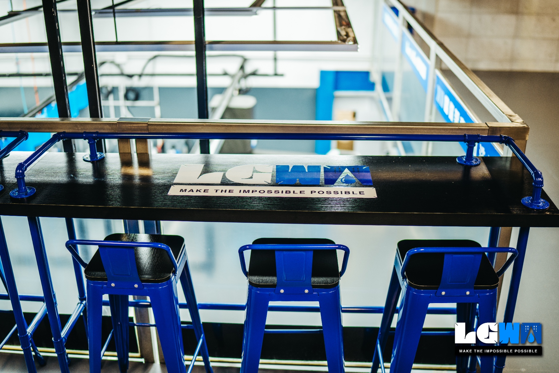 LETS GET WASH second floor British industrial style car owner's lounge with blue bar