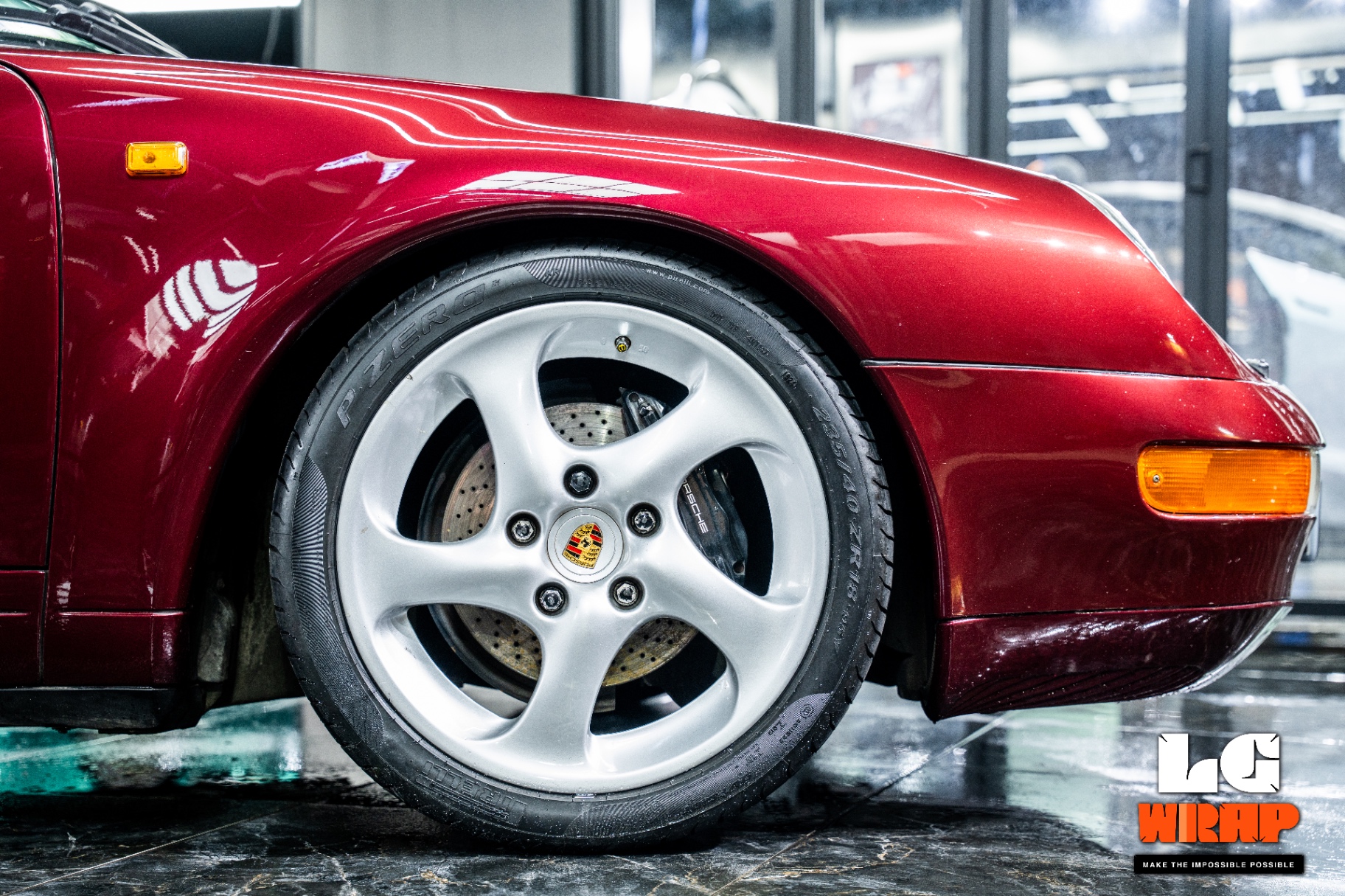 Porsche 993 front fender and wheels after coating showing deep burgundy mirror reflection