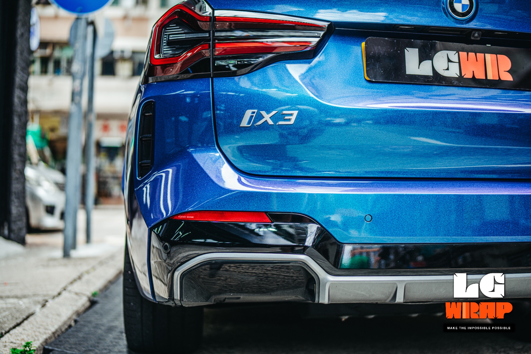 Close-up of the rear of a blue BMW iX3, showcasing the deep reflection after GSWF full-body transparent PPF