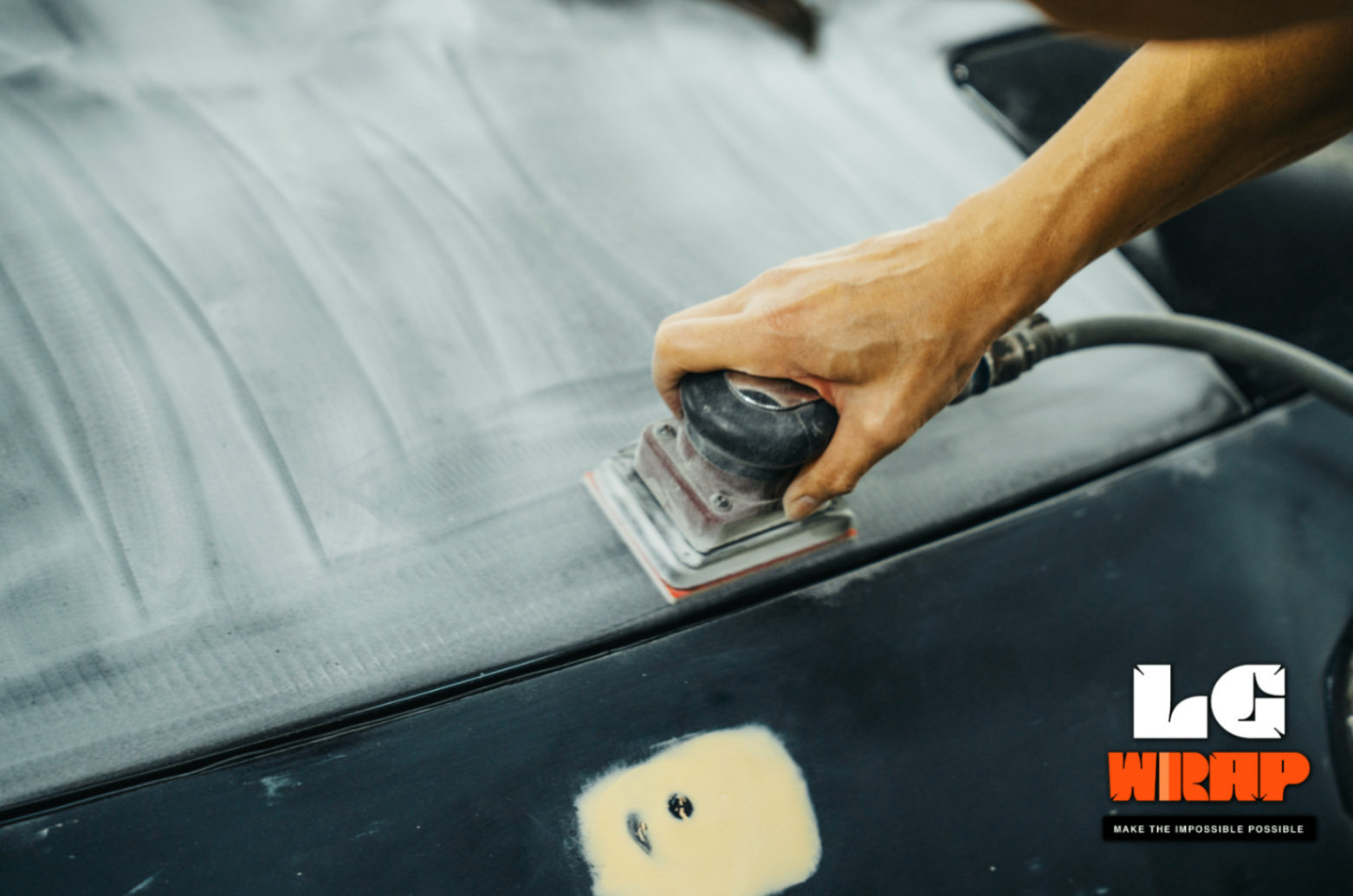 Close-up of pneumatic sanding on the Mazda MX-5 NA's bonnet