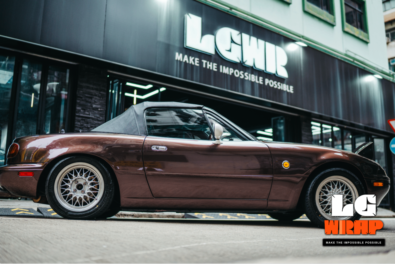 Side street shot of the completed Mazda MX-5 NA, showcasing classic lines and BBS wheels
