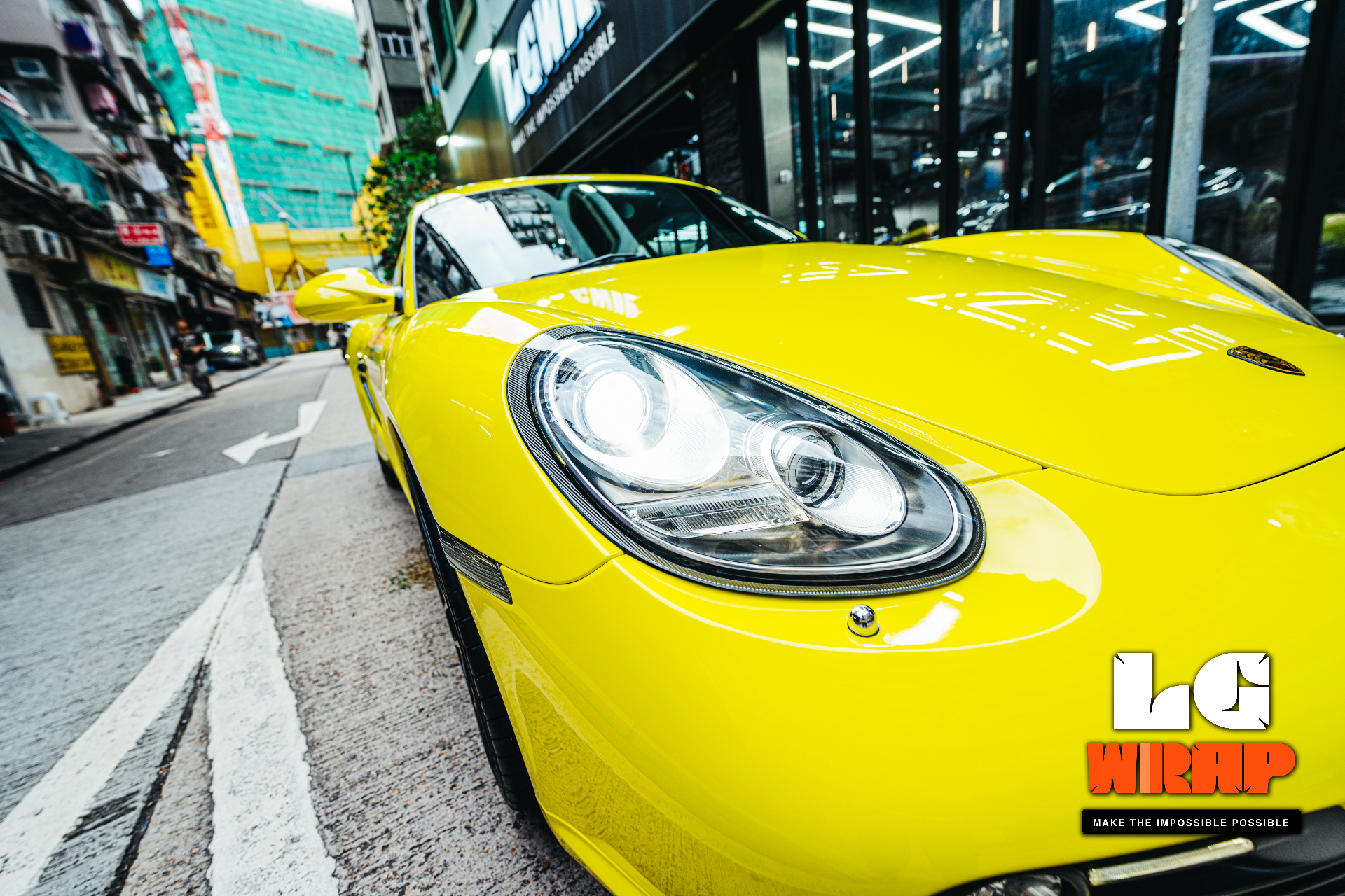 Close-up of a yellow Porsche's front end, showing its low profile and large frontal area