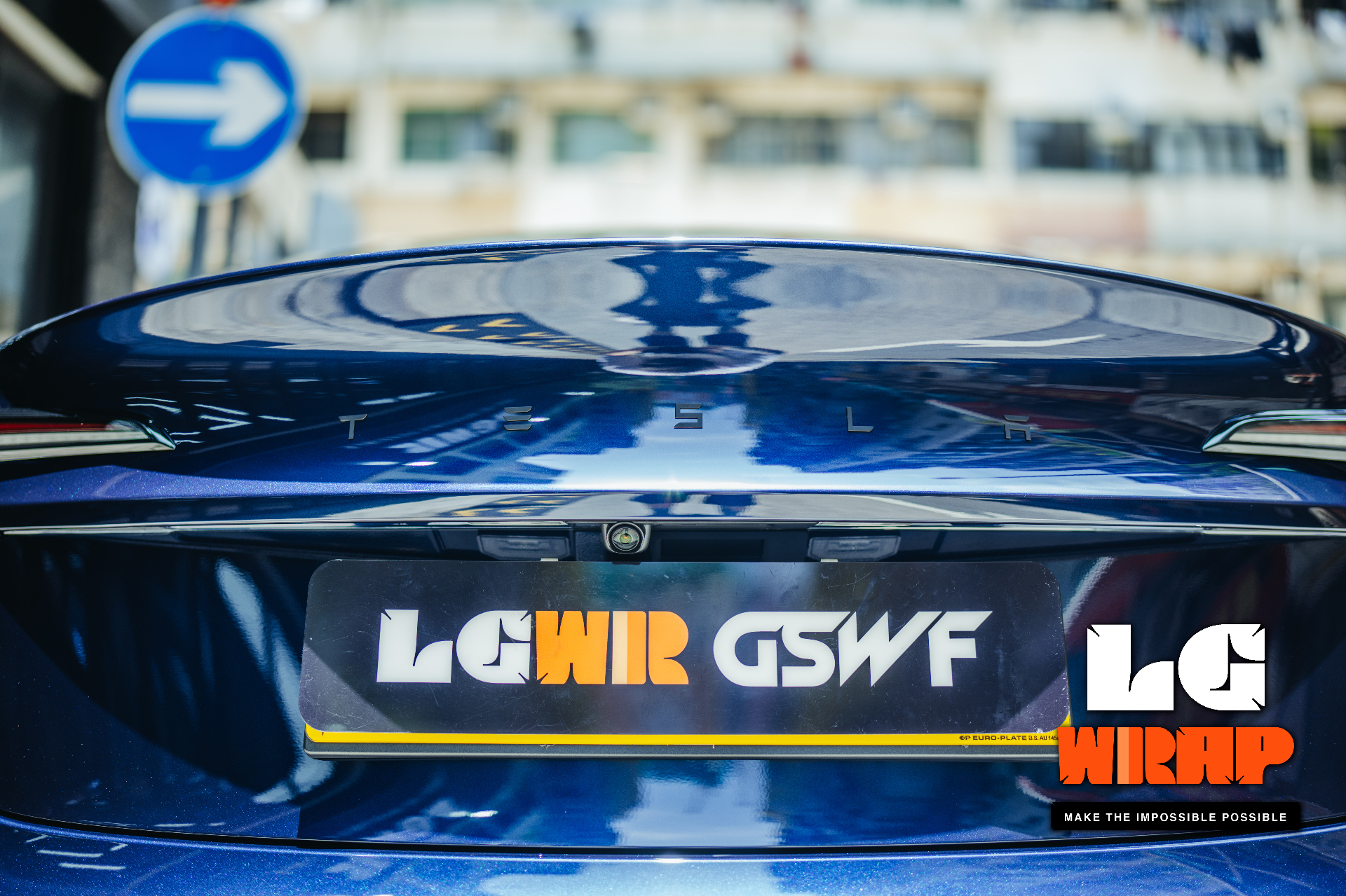 Close-up of a dark blue Tesla Model 3 rear, showing mirror reflection after GSWF PPF and LGWR license plate